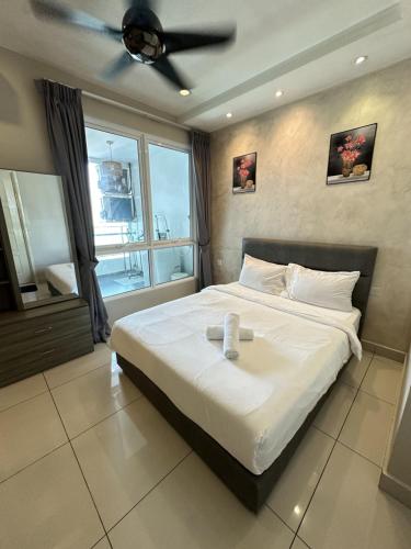 a bedroom with a large bed with a ceiling fan at HappySty George Town Gurney Mansion one 26 in George Town