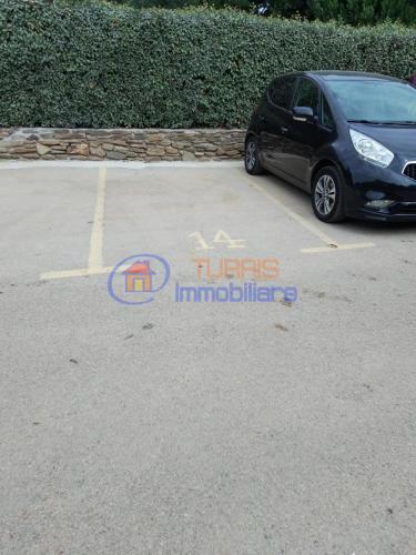 a car parked in a parking lot with a tucks international logo at I Mirti in Stintino