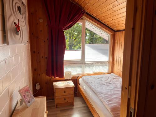 a small bedroom with a bed and a window at Ferienhaus Vita in Extertal