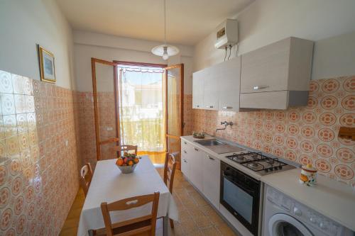 a kitchen with a table and a stove top oven at Mati in Poesia - San Foca in Melendugno
