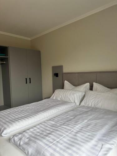 two beds sitting next to each other in a bedroom at Hotel Ostseeblick - direkt hinter den Dünen in Ostseebad Karlshagen