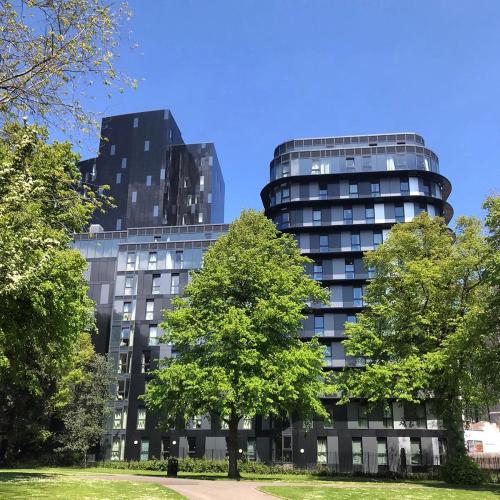 a tall building with a tree in front of it at Yugo Catherine House Portsmouth in Portsmouth