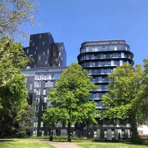 a tall black building with trees in front of it at Yugo Catherine House Portsmouth in Portsmouth