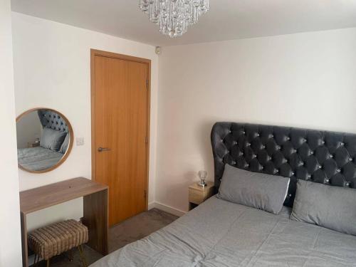 a bedroom with a large bed and a mirror at Central Liverpool Apartment-Sleeps 6-Free Parking in Liverpool