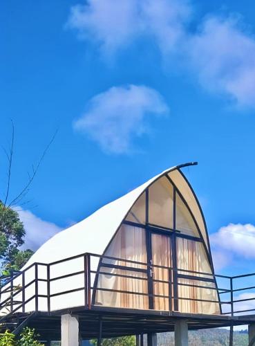 a dome shaped building with a white roof at Cocoon Creek in Kodaikānāl