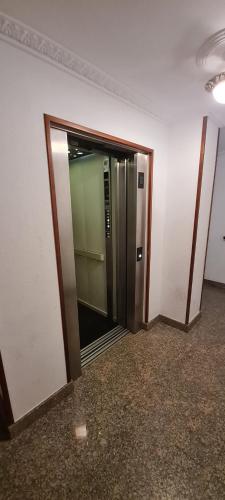 an elevator in an office building with its door open at El apartamento de arriba in Cedeira