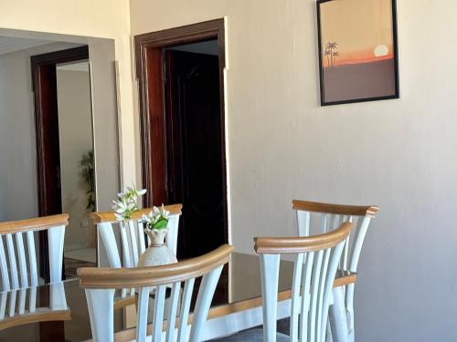 a group of chairs in a room with a mirror at Elite Apartments in Mohandseen - Families only in Cairo