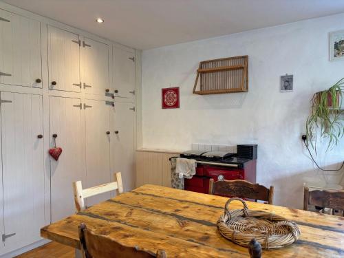a dining room with a wooden table with a basket on it at Cottage 484 - Moyard in Moyard