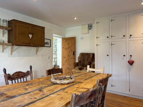 a kitchen with a large wooden table and chairs at Cottage 484 - Moyard in Moyard