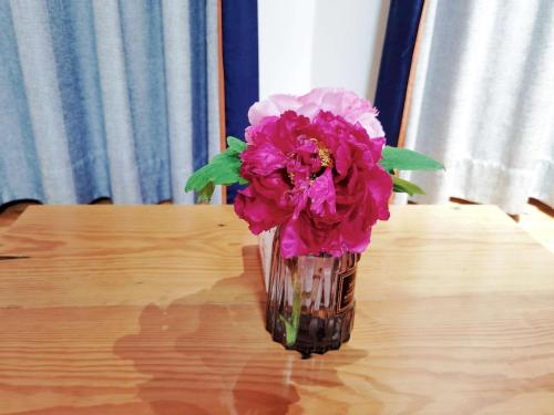 a vase filled with pink flowers sitting on a table at 淳安千岛湖乡庐怡陌民宿 in Thousand Island Lake