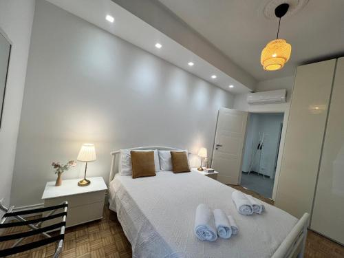 a bedroom with a bed with towels on it at Rosa Bianca apartment - Free Parking in the historic center of Alba - Langhe in Alba