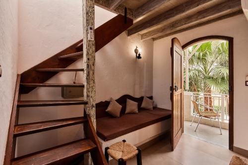 a room with a couch in a house at Mila Malia Studios Hotel in Malia
