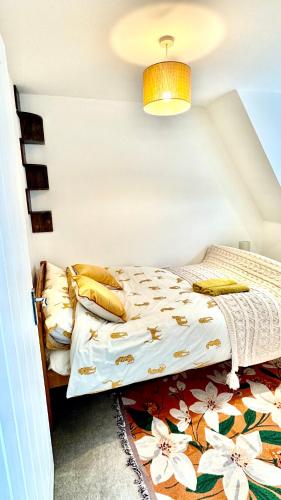 a bedroom with a bed with a flower patterned blanket at Five bedroom family house in St. Leonards
