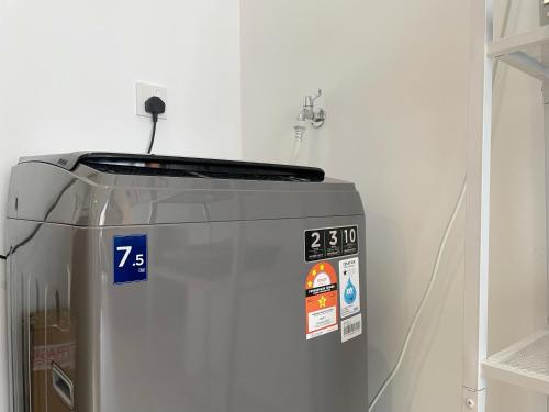 a refrigerator with stickers on it in a room at Le Petit Suite - 8 Pax Sea View Infinity Pool in George Town
