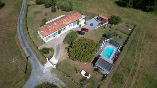 an aerial view of a house with a swimming pool at Maison Neuve, relaxing countryside home with pool in Chillac