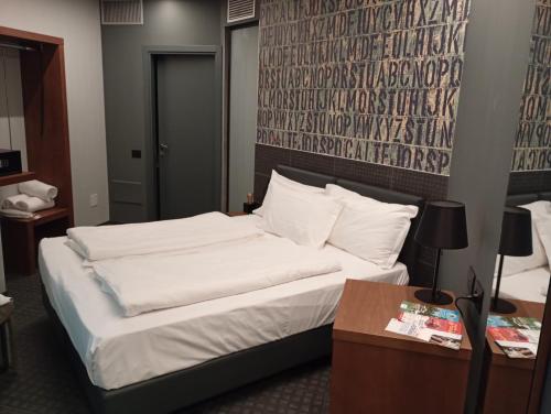 Postel nebo postele na pokoji v ubytování WEGA Hotel Verona