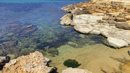 a body of water with rocks and the water at Le Sciare di Torretta Granitola in Campobello di Mazara