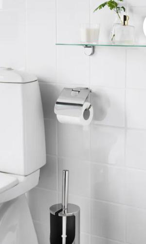 a white bathroom with a toilet and a shelf at Habitacion E in Zaragoza
