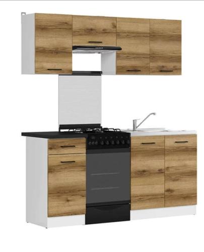 a kitchen with a black counter top and wooden cabinets at Habitacion E in Zaragoza