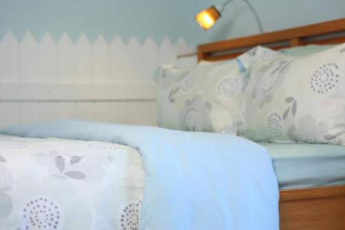 a bed with white sheets and pillows on it at Huxi B&B in Jian