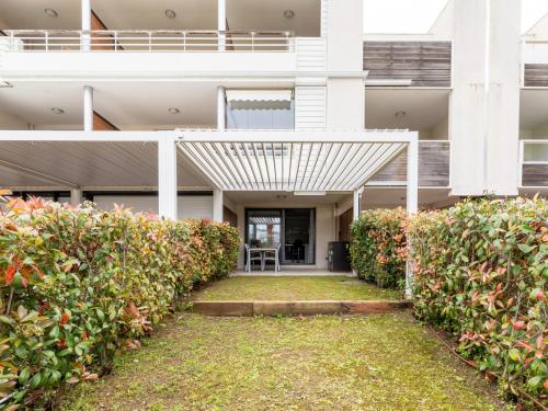 an external view of a building with awning and bushes at Carre Marine N12 - 2P4 in Mandelieu-la-Napoule