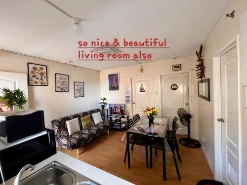 a living room with a table and a couch at Two-Bedroom at San Remo Oasis in Cebu City