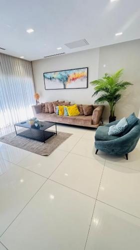 a living room with a couch and a table at sea view Vila-5BDR in Netanya