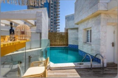 a swimming pool on top of a building at sea view Vila-5BDR in Netanya