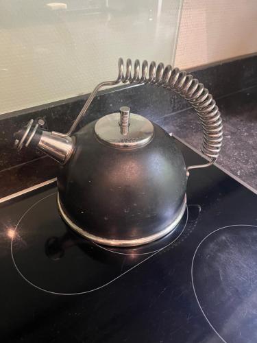 a tea pot sitting on top of a stove at Broekemmolen - Nature getaway & green spot in Bilzen