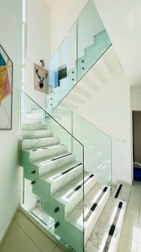 a glass stair case in a room with at sea view Vila-5BDR in Netanya