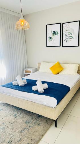 a bedroom with a large bed with towels on it at sea view Vila-5BDR in Netanya
