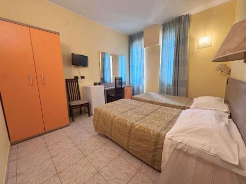a hotel room with a bed and a desk at Hotel Valganna in Milan