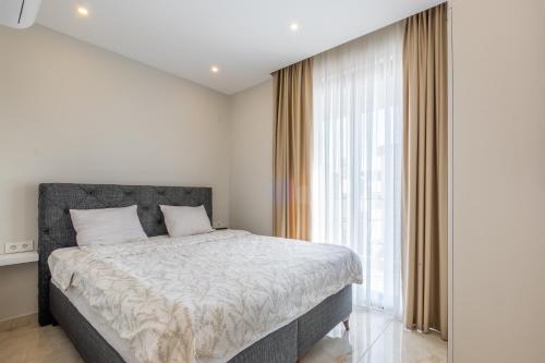 a bedroom with a bed and a large window at Jasmin 8 2+1 NEW! in Alanya
