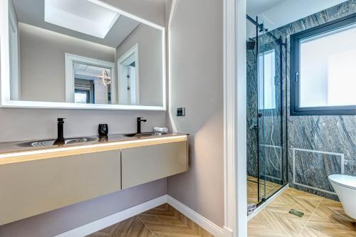 a bathroom with a sink and a shower at Villa Arthur in Kassiopi