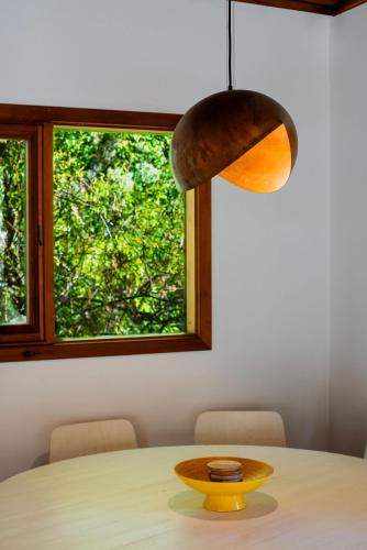a dining room table with a pendant light at Stirling Creek Cottage in Stirling