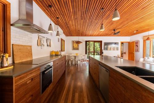 a large kitchen with wooden cabinets and a counter top at Stirling Creek Cottage in Stirling