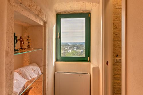 a window in a room with a view of a city at CRIO - Experiences at home in Cisternino