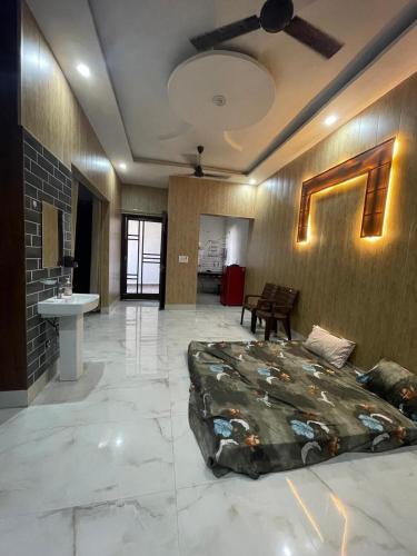 a bedroom with a large bed and a sink at Independent House, 2 Bedroom, 2 Bath Livingroom,Lobby,kitchen,car parking in Amritsar