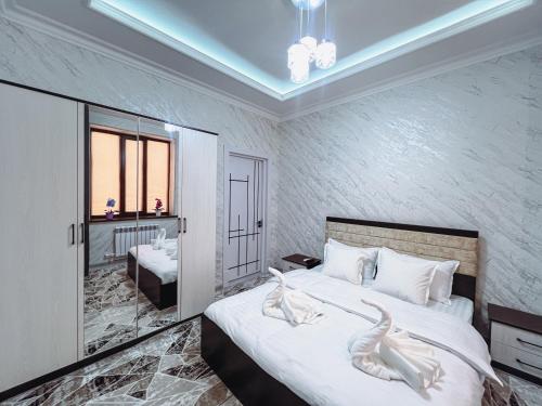 a bedroom with a bed with two swans on it at Cozy Luxury in Samarkand