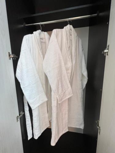 a group of towels hanging on a rack in a closet at Cozy Luxury in Samarkand