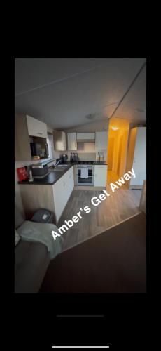 a small kitchen with a sink and a stove at Amber’s Get Away in Skegness