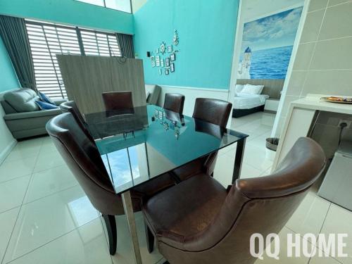 a dining room with a glass table and leather chairs at Nice Seaview Water Front Apartment 3R3B 超舒适海景房间-3房3卫 in Port Dickson