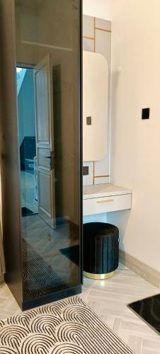 a bathroom with a mirror and a stool in a room at Classic Resort Puncak in Campaka