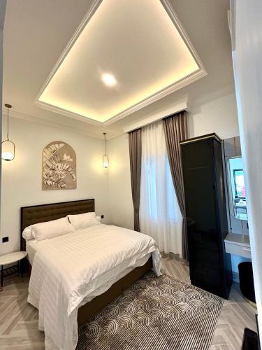 a bedroom with a large white bed and a window at Classic Resort Puncak in Campaka