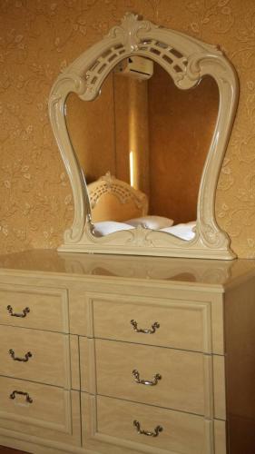 a dresser with a mirror on top of it at Hostelhome in Türkistan