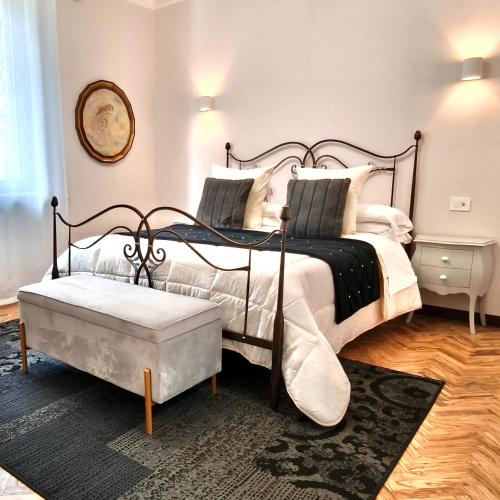 a bedroom with a black and white bed and a table at Villamena in Spello