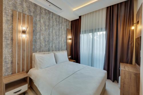 Postel nebo postele na pokoji v ubytování Ege Birlik Seasight Suites