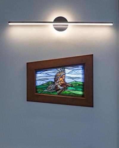 a stained glass window of a bird on a wall at Eagle Ridge Retreat in Kettering