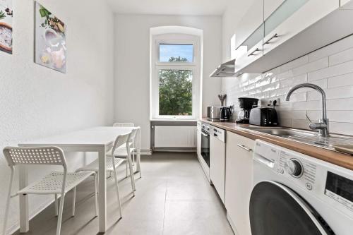 a kitchen with a sink and a table and a washing machine at Nice Apartment in Eberswalde in Eberswalde