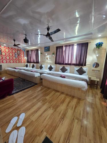 a large living room with two large beds in it at Hotel Young Mamta in Srinagar